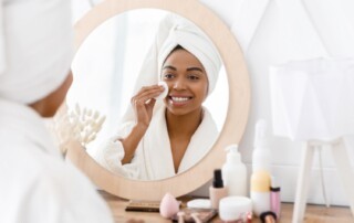 Woman applying something to her skin as part of her skincare routine